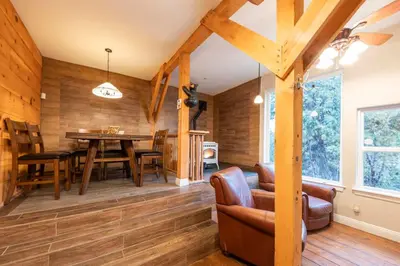 a dining room with wooden walls and a table and chairs at Historic Mountain Retreat - Near Boreal - 3 Kings in Emigrant Gap