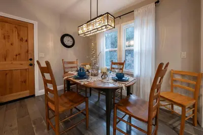 a dining room with a table and chairs and a clock at Historic Mountain Retreat - Near Boreal - 3 Kings in Emigrant Gap