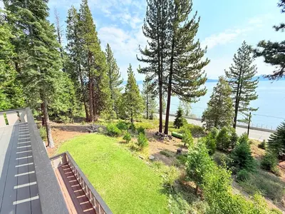 a view of a yard with trees and the ocean at Lake Tahoe Cabin I Hammocks, Paddle Boards and Bikes in Homewood
