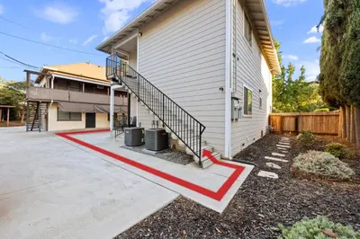 a house with a red stripe on the side of it at Cozy Nest Across the street from UC Davis Sacramento in Sacramento
