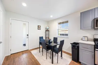 a kitchen and dining room with a table and chairs at Cozy Nest Across the street from UC Davis Sacramento in Sacramento
