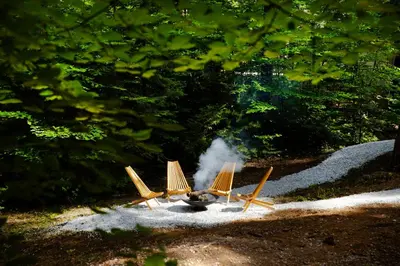 a fire pit with four small planes on the ground at A-Frame Cabin - Sauna, Hot Tub, Fire Pit, Projector in Arnold