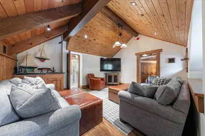 a living room with two couches and a tv at Beyond the Blue Lakefront Escape by Tahoe Getaways - Pet-Friendly 6BR with Pier, Buoy & Hot Tub in Carnelian Bay