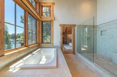 a large bathroom with a tub and a glass shower at Beyond the Blue Lakefront Escape by Tahoe Getaways - Pet-Friendly 6BR with Pier, Buoy & Hot Tub in Carnelian Bay
