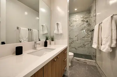 a white bathroom with a sink and a shower at Shining Creek at Alpine Meadows by Tahoe Getaways - 4 BR w Creek Views, Hot Tub & Ski Shuttle! in Alpine Meadows