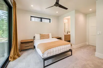 a bedroom with a bed and a ceiling fan at Shining Creek at Alpine Meadows by Tahoe Getaways - 4 BR w Creek Views, Hot Tub & Ski Shuttle! in Alpine Meadows