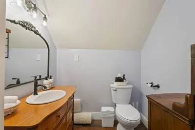 a bathroom with a white toilet and a sink at Historic 1914 Cottage, Near Downtown, UNR & Hospitals, Early Check In in Reno