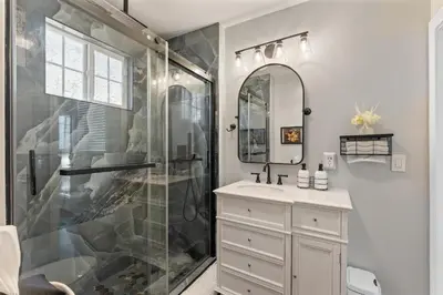 a bathroom with a shower and a sink at Historic 1914 Cottage, Near Downtown, UNR & Hospitals, Early Check In in Reno