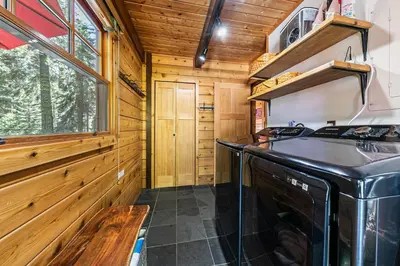 a kitchen with a stove and a sink at Classic Cabin in the Pines by Tahoe Getaways - Walk to Lake, Pet-Friendly 3 BR w Yard & Hot Tub! in Homewood