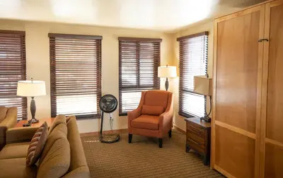 a living room with a couch and a chair and windows at Kingsbury of Tahoe in Stateline