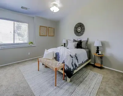 a bedroom with a bed and a chair and a window at Cozy Room#1 Best Moscato in Clovis
