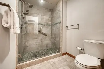 a bathroom with a glass shower with a toilet at Emerald Lodge at Tahoe Park by Tahoe Getaways - 4BR w HOA Beach & Air Conditioning in Tahoe City