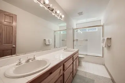 a white bathroom with a sink and a toilet at Emerald Lodge at Tahoe Park by Tahoe Getaways - 4BR w HOA Beach & Air Conditioning in Tahoe City