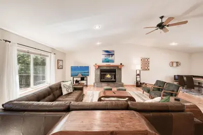 a living room with a couch and a fireplace at Emerald Lodge at Tahoe Park by Tahoe Getaways - 4BR w HOA Beach & Air Conditioning in Tahoe City