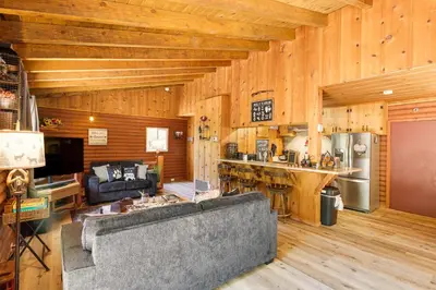 a living room with a couch and a kitchen at Community Lake Access Peaceful Cabin in Sonora! in Sonora