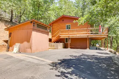 a house with a deck on the side of it at Community Lake Access Peaceful Cabin in Sonora! in Sonora