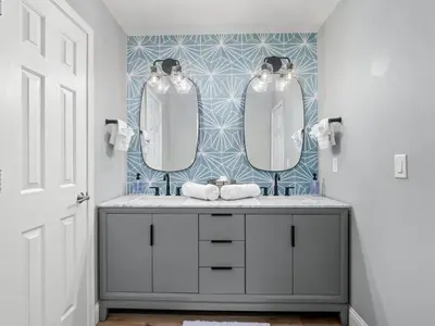 a bathroom with two mirrors and a sink at Serene Views with Hot Tub, BBQ, Fire Pit, Game Room in Oakhurst