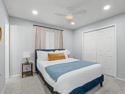 a bedroom with a large bed with a blue headboard at Serene Views with Hot Tub, BBQ, Fire Pit, Game Room in Oakhurst
