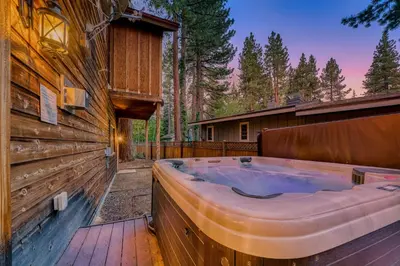 a hot tub on the side of a house at Tahoe Island Retreat Hot Tub & Game Room in South Lake Tahoe