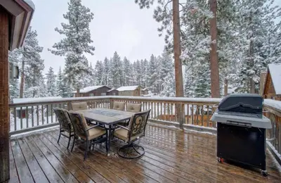 a table and chairs on a deck with a grill at Tahoe Island Retreat Hot Tub & Game Room in South Lake Tahoe