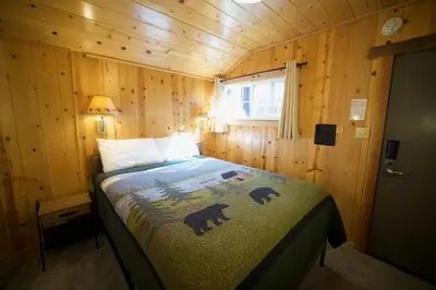 a bedroom with a bed in a wooden cabin at Tamarack Lodge Motel in Tahoe City