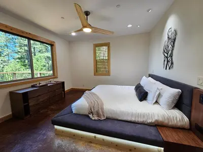 a bedroom with a bed and a ceiling fan at Cedar Rock Cabin in Mi-Wuk Village