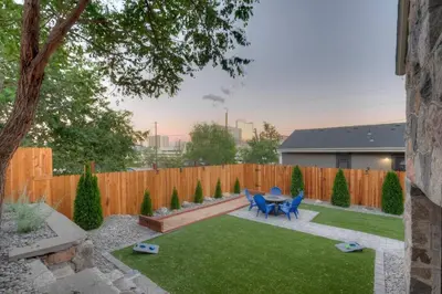 a backyard with a table and chairs and a fence at Historic Stone House-Reno-UNR-Family in Reno