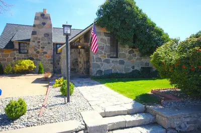 a house with an american flag in front of it at Historic Stone House-Reno-UNR-Family in Reno
