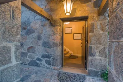 a hallway with a stone wall with a doorway at Historic Stone House-Reno-UNR-Family in Reno