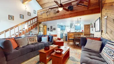 a living room with a couch and a table at Mammoth Sierra Townhomes #25 condo in Mammoth Lakes