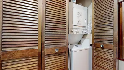 a bathroom with a wooden wall next to a toilet at Mammoth Sierra Townhomes #25 condo in Mammoth Lakes