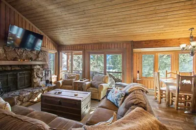 a living room with a couch and a fireplace at Corner 3BD with Loft! Walk to Canyon and The Village! in Mammoth Lakes