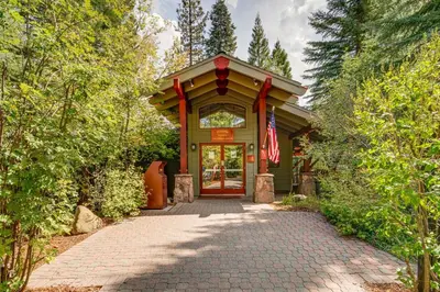 a house with a flag in front of a driveway at Northstar Ski-InandOut Condo with Resort Amenities! in Truckee