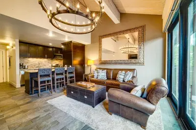 a living room with a couch and a table at Northstar Ski-InandOut Condo with Resort Amenities! in Truckee