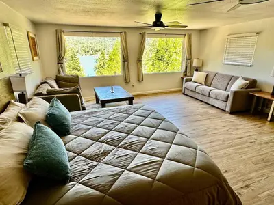 a living room with a large bed and a couch at Lake View Suite for 2-Hot Tub-Dog Friendly in Bass Lake Annex