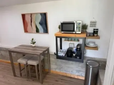 a room with a table and a table and a microwave at Lake View Suite for 2-Hot Tub-Dog Friendly in Bass Lake Annex