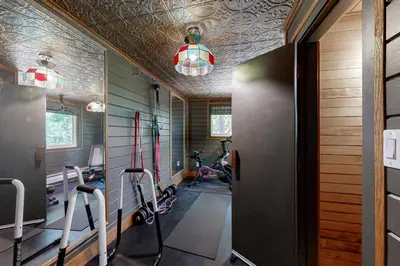 a gym with treadmills and exercise bikes in a room at Hot Tub, Game Room and Home Gym Serene Arnold Gem in Arnold