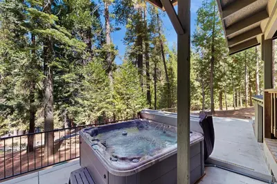a hot tub on a deck with trees in the background at Hot Tub, Game Room and Home Gym Serene Arnold Gem in Arnold
