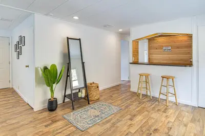 a room with a mirror and two bar stools at Mtn-View Coulter Escape with Rustic Tree Lookout in Coulterville