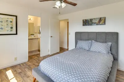 a bedroom with a bed and a ceiling fan at Mtn-View Coulter Escape with Rustic Tree Lookout in Coulterville