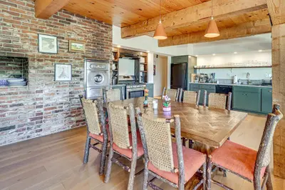a kitchen and dining room with a wooden table and chairs at Endless Mtn Views! Group Ski Lodge at Sugar Bowl in Norden