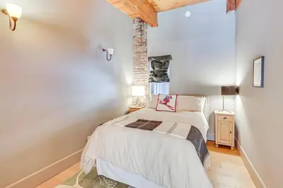 a small bedroom with a bed and a window at Endless Mtn Views! Group Ski Lodge at Sugar Bowl in Norden