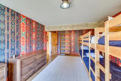 a bedroom with two bunk beds and colorful wallpaper at Endless Mtn Views! Group Ski Lodge at Sugar Bowl in Norden