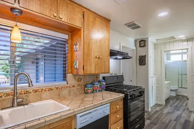 a kitchen with a sink and a stove at Cozy Cabin by Bass Lake, with Boat Slip in Bass Lake