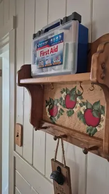 a wooden shelf with a box of first aid on it at Cozy Cabin by Bass Lake, with Boat Slip in Bass Lake