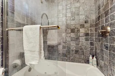 a bathroom with a shower with a tub and a towel at Tahoe Timber Retreat in Carnelian Bay