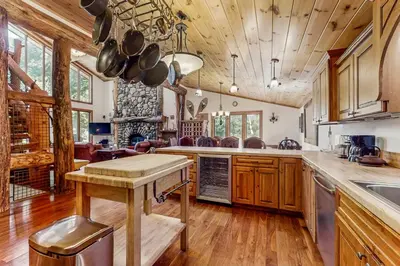 a large kitchen with wooden cabinets and a table at Tahoe Timber Retreat in Carnelian Bay