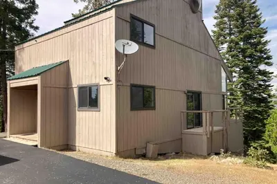 a building with a basketball hoop on the side of it at Dogwood Hollow in Shaver Lake
