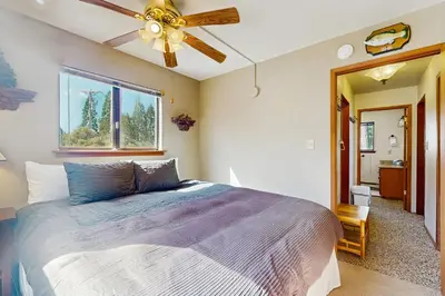 a bedroom with a bed and a ceiling fan at Dogwood Hollow in Shaver Lake