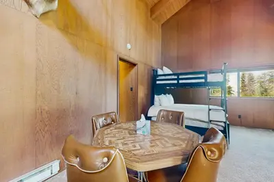 a room with a table and chairs and a bed at Dogwood Hollow in Shaver Lake